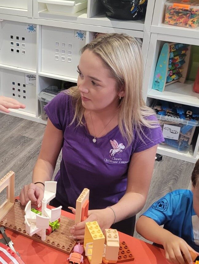 Lilli, a member of staff, playing with children at Chris's Childcare